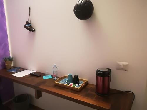 a desk with a coffee cup and a notebook on it at Luci A San Siro in Milan