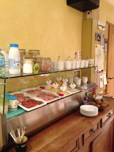 a kitchen with a counter with meat and other foods at Le Clos Margot in Vertus