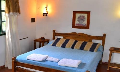 Un pat sau paturi într-o cameră la Chawasi Cabañas