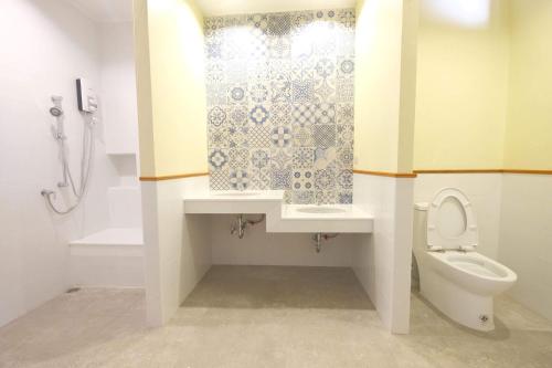a bathroom with a toilet and a sink and a shower at Baan Imm Sook Resort in Chao Lao Beach
