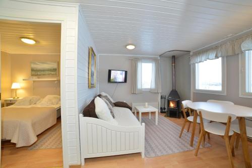 a bedroom with a bed and a table and a dining room at Guesthouse Haltinmaa in Kilpisjärvi