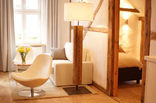a living room with a chair and a bed at Zajazd Karczma Zagłoba in Świdnica