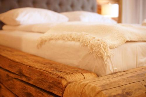 a bed with white sheets and pillows on it at Zajazd Karczma Zagłoba in Świdnica