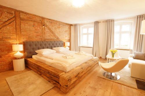 a bedroom with a bed and a brick wall at Zajazd Karczma Zagłoba in Świdnica