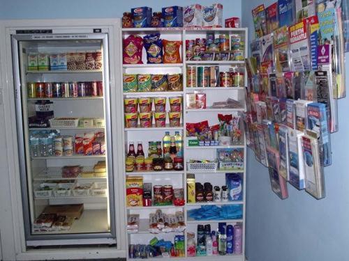 a refrigerator with its door open with food and drinks at Mountway Holiday Apartments in Perth