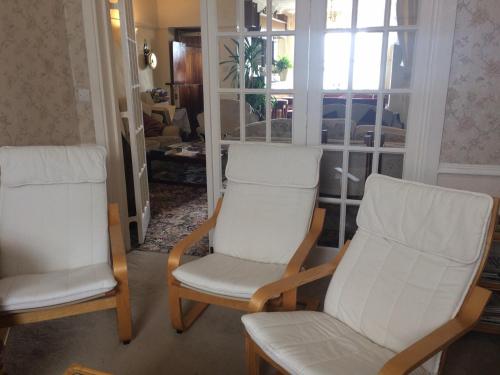 two chairs in a living room with a window at The Whiteley in Scarborough