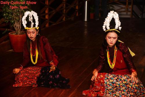 two women sitting on the floor in traditional costumes at Kuti Resort & Spa in Pokhara
