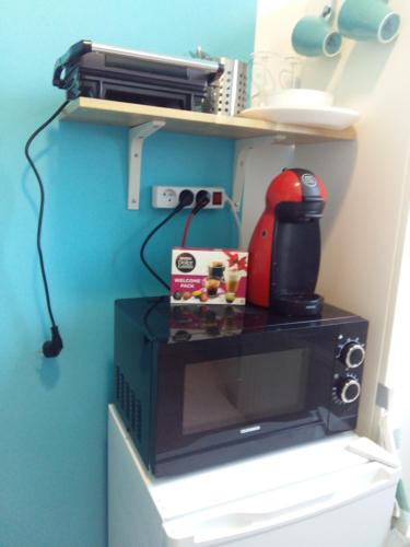 a microwave on a shelf in a room at Private Studio Brussels Airport in Brussels