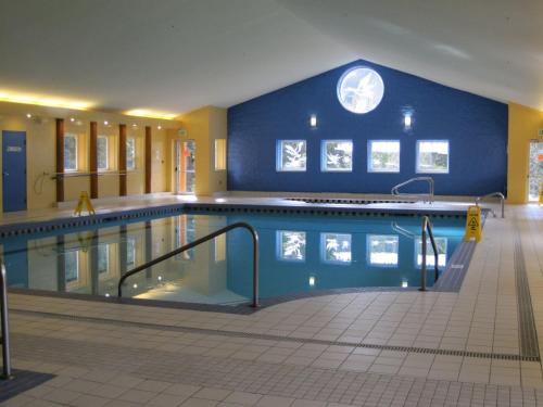 a large swimming pool with a blue wall at Manning Park Resort in Manning Park