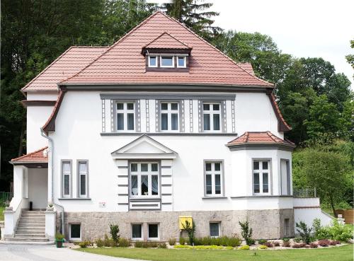 a white house with a red roof at Villa Adam in Pieszyce