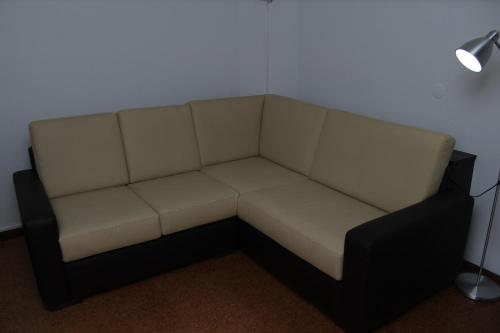 a white couch in a room with a lamp at Hotel Oasis in Santa Marta de Penaguião