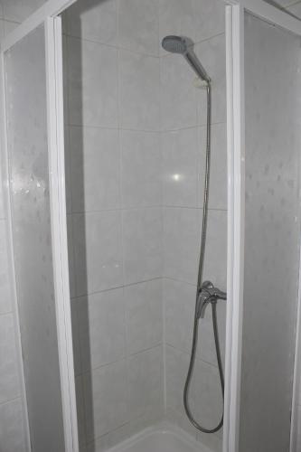 a shower with a shower head in a bathroom at Hotel Oasis in Santa Marta de Penaguião