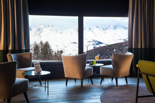 a living room filled with furniture and a window at Araucaria Hotel & Spa in La Plagne