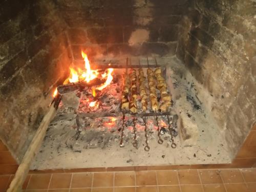 a brick oven with a bunch of food cooking at Mia B&B Tbilisi in Tbilisi City