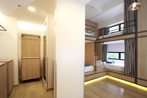 a small bedroom with bunk beds and a hallway at Lub d Manila Makati - Central Makati, Near Nightlife in Manila