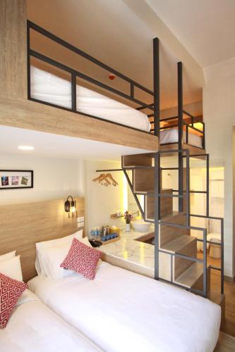 a bedroom with a bunk bed and a staircase at Lub d Manila Makati - Central Makati, Near Nightlife in Manila