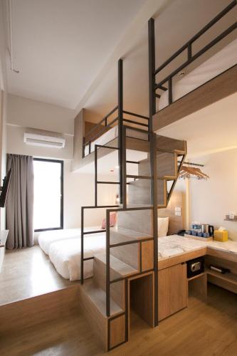 a bedroom with a loft bed with a desk and a bunk bed at Lub d Manila Makati - Central Makati, Near Nightlife in Manila