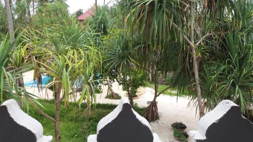 a view of a resort with palm trees and a pool at Laguna Palace Zanzibar in Michamvi