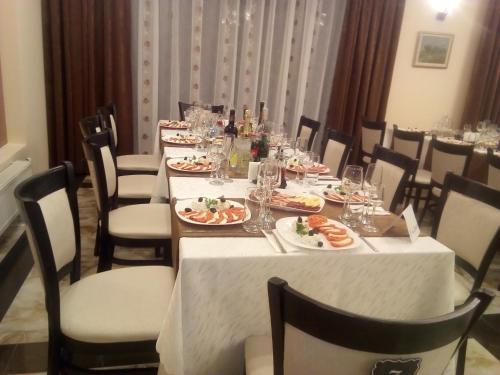 a dining room with a table with plates of food at Park-Hotel Yambol in Yambol