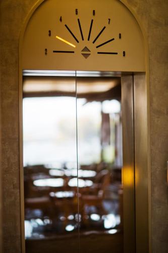 an elevator door with a clock on top of it at Ryugu Hotel in Nishio