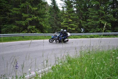a person riding a motorcycle on a road at Moar's Hotel in Valdaora