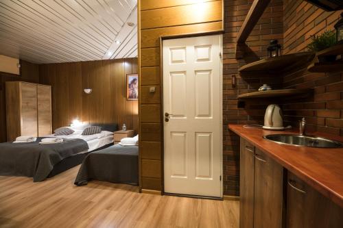 a bedroom with two beds and a sink in a room at Golden Lion Guest Rooms Szewska 19 in Kraków