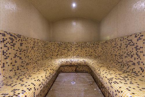 a large shower with a tiled wall at Hotel Iceberg Bansko in Bansko