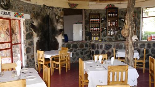 a restaurant with tables and chairs in a room at Sora Lodge Lalibela in Lalībela