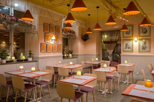 a restaurant with tables and chairs and lights at Lady Hamilton Apartments in Stockholm