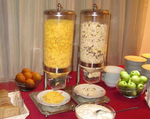 a table with two tall vases filled with food at Park Hotel Moskva in Sofia