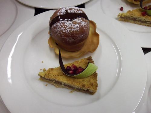 a white plate topped with a doughnut and a dessert at Agriturismo la Sforzata in Collegno