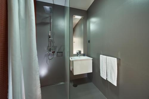 a bathroom with a shower and a sink and a mirror at Funchal Charming Villa in Funchal