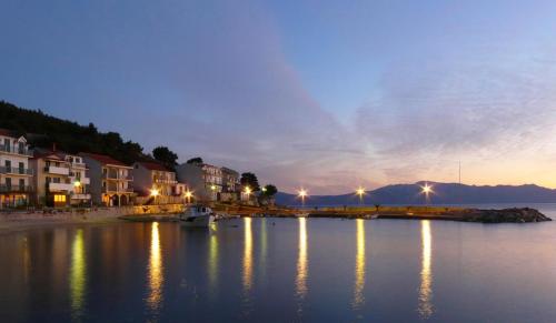 a view of a river at night with houses and lights at Apartmani Kežić Drvenik in Drvenik