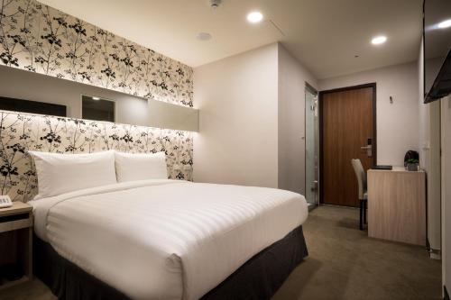 Postel nebo postele na pokoji v ubytování 碩城文旅 SC Hotel