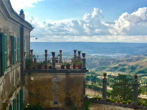 a balcony with potted plants on top of a building at La Corte Di Alice in Lugnano in Teverina