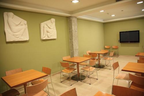 a classroom with tables and sculptures on the wall at Cesaraugusta in Zaragoza