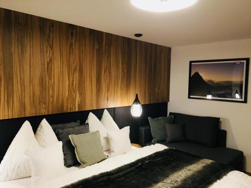 a bedroom with a large bed and a couch at Ferienwohnung Lederer in Fieberbrunn