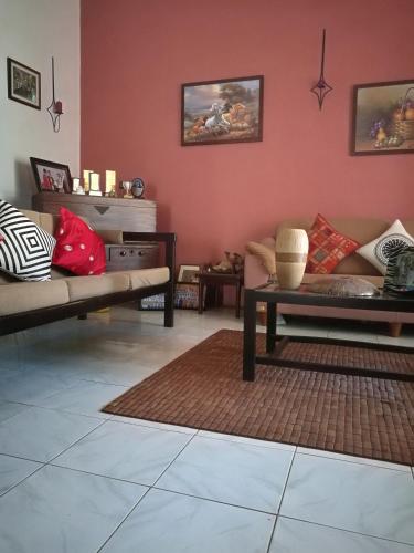 a living room with two couches and a table at Villa A50 in Negombo
