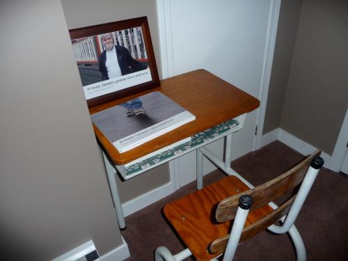 a desk with a picture and a wooden chair at Cycle Inn Bed and Breakfast in Langford