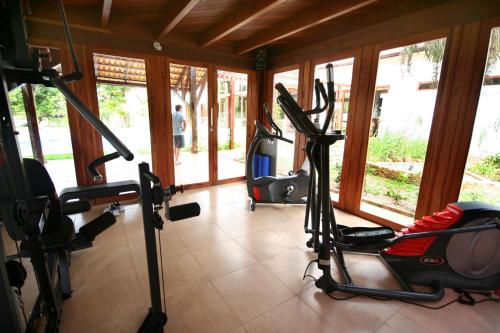 a gym with cardio equipment in a room with windows at Refúgios Parajuru in Parajuru