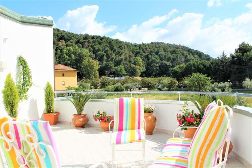 a patio with two chairs and a view of a mountain at Mariposa in Telese