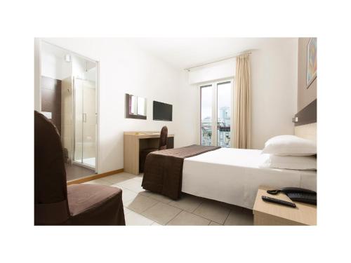 Ένα ή περισσότερα κρεβάτια σε δωμάτιο στο Hotel Gardenia