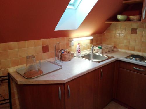 a kitchen with a sink and a counter top at Ottó Panzió Villány in Villány