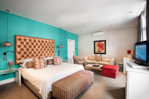 a hotel room with two beds and a television at The Grand Daddy in Cape Town