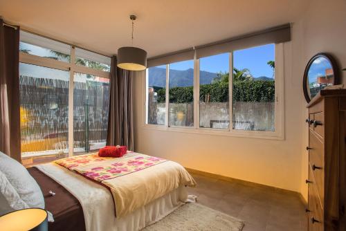 a bedroom with a bed and a large window at Casa Castillo in Los Realejos
