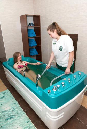 a woman in a boat with a woman inside at Green Park Hotel & SPA in Truskavets