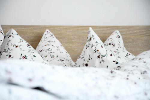 a group of white pillows on a bed at Architectural City Loft in Sofia
