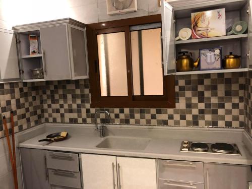 a kitchen with a sink and a counter top at شامة جدة للشقق المخدومة in Jeddah