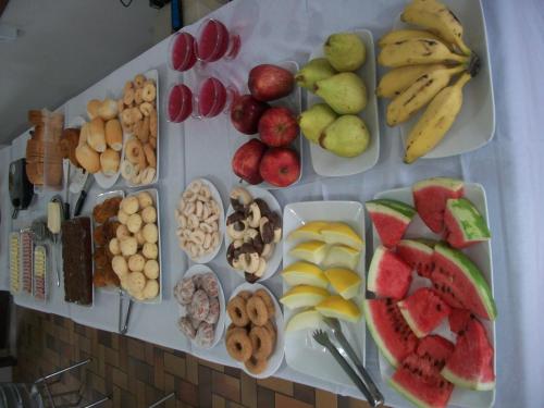 una tabella piena di diversi tipi di frutta e verdura di Hotel Vila Mineira a Oliveira