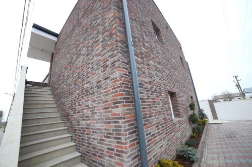 a brick building with stairs next to it at Fresh Accommodation in Rădăuţi